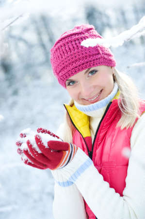 Smiling beautiful woman playing with snow 

の写真素材