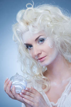 Beautiful snow queen with a christmas ball の写真素材