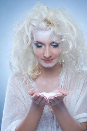 Snow queen playing with snow の写真素材