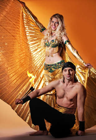 Arabic dancer with a handsome men performing fire showの写真素材