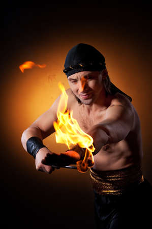 Handsome men performing fire showの写真素材