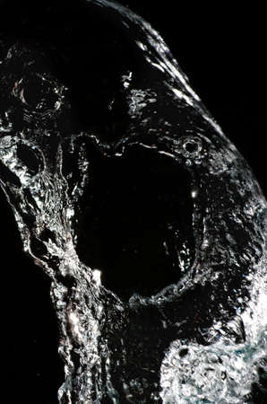 Stylish water splash. Isolated on black background 
の写真素材