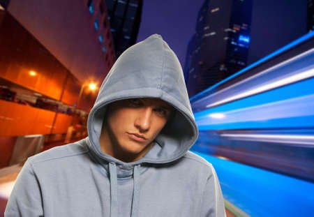 Handsome young men behind night cityの写真素材