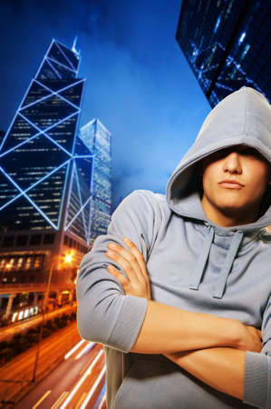 Handsome young men behind night cityの写真素材