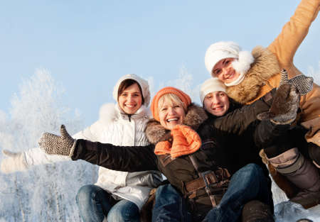 Happy friends on a winter backgroundの写真素材