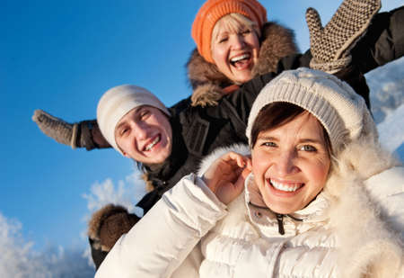Happy friends on a winter background の写真素材