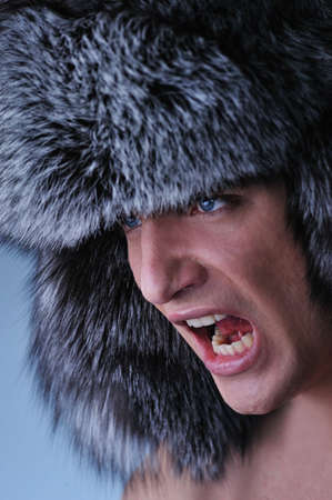Portrait of handsome young man wearing fluffy hatの写真素材