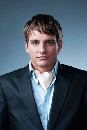 Handsome young businessman isolated on grey backgroundの写真素材