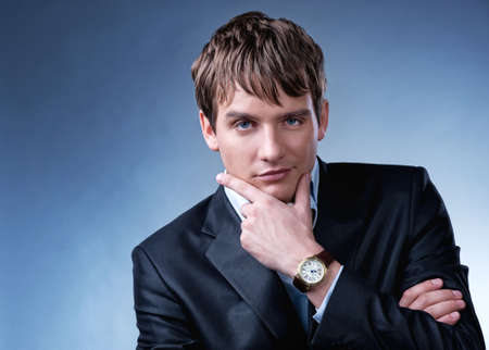 Handsome young businessman isolated on grey backgroundの写真素材
