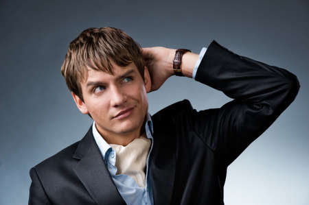 Handsome young businessman isolated on grey backgroundの写真素材