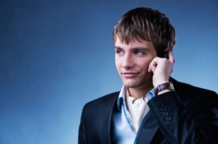 Handsome young businessman with a mobile phoneの写真素材