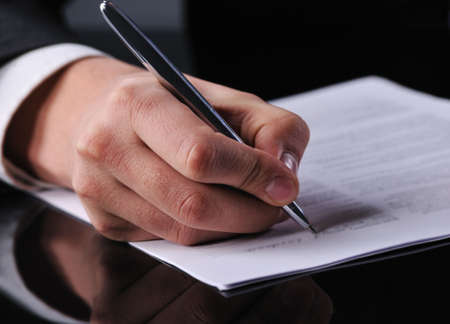businessman writing on a form の写真素材