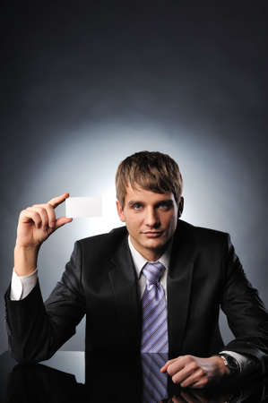 Business man handing a blank business card の写真素材