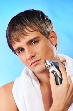 Handsome young man shavingの写真素材