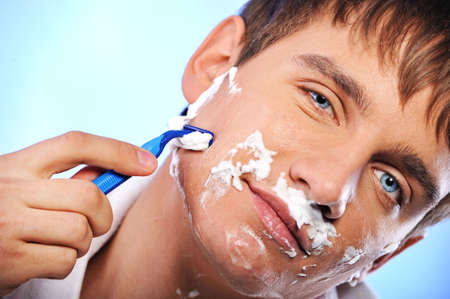 Handsome young man shavingの写真素材