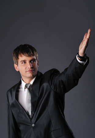 Handsome young businessman with outstretched handの写真素材
