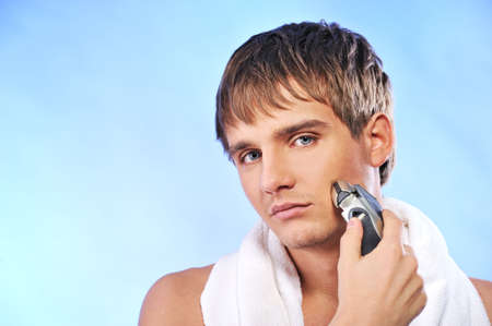 Handsome young man shaving 
の写真素材
