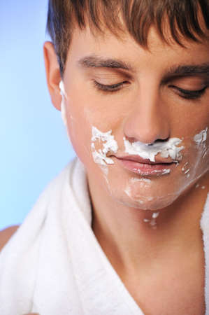 Handsome young man shaving 
の写真素材
