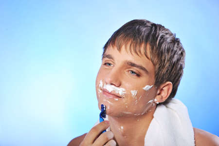 Handsome young man shaving 
の写真素材