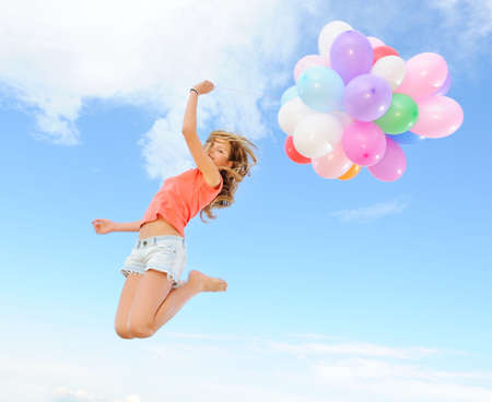 Happy girl with colorful balloons の写真素材