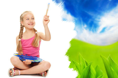 Beautiful little girl painting nature landscapeの写真素材