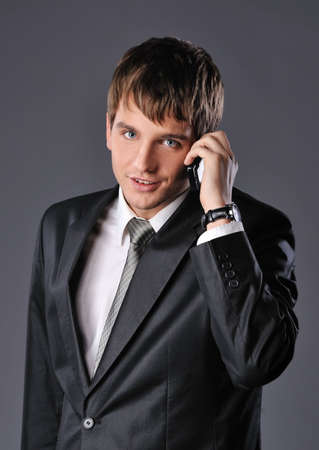 Handsome young businessman talking on mobile phone 

の写真素材