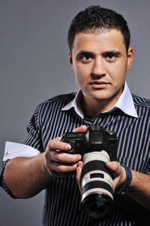 Handsome man with a photocameraの写真素材