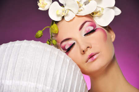 Beautiful woman with creative make-upの写真素材