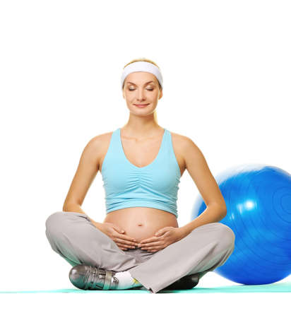 Young pregnant woman making exercise の写真素材