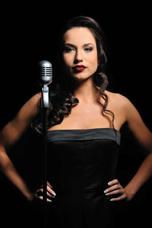 Attractive brunette woman with a retro microphone 
の写真素材