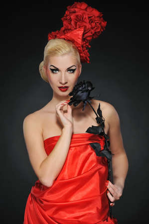 Beautiful lady with black rose. Close-up portraitの写真素材