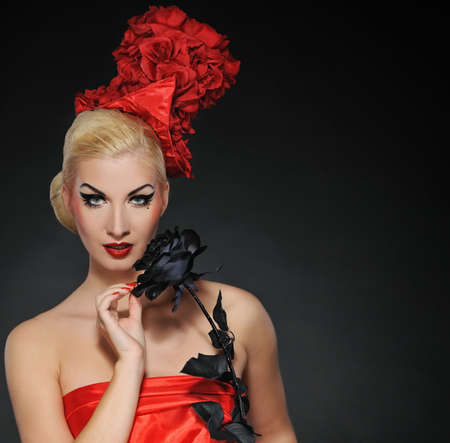 Beautiful lady with black rose. Close-up portraitの写真素材