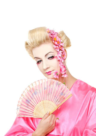 Beautiful geisha with a fan. Isolated on white backgroundの写真素材