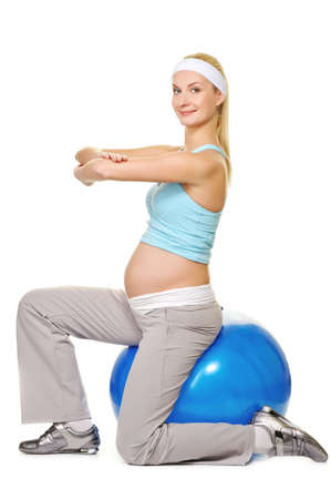 Young pregnant woman making exercise on a fitness ball 
の写真素材