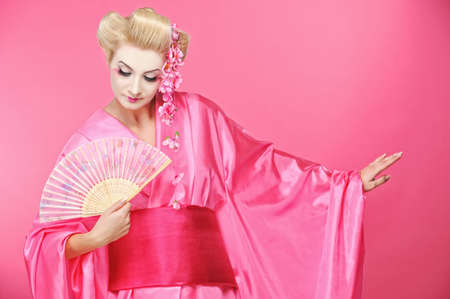Portrait of a beautiful geisha with fan の写真素材