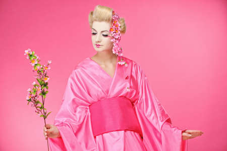 Beautiful geisha with a sacuraの写真素材