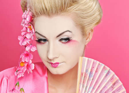 Beautiful geisha with a fanの写真素材