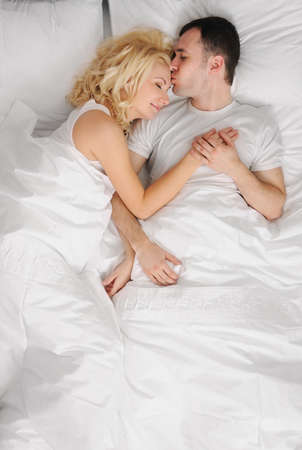 Young couple sleeping in a bed の写真素材