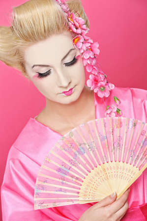Beautiful geisha with a fan の写真素材