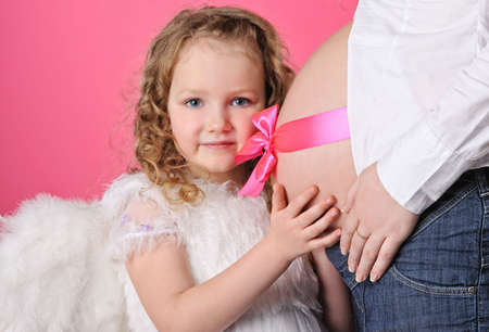 Angel girl and beautiful pregnant bellyの写真素材