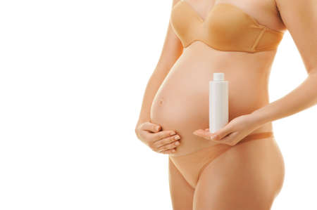 Pregnant woman with a bottle of oilの写真素材