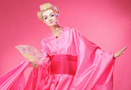 Beautiful geisha with a fanの写真素材
