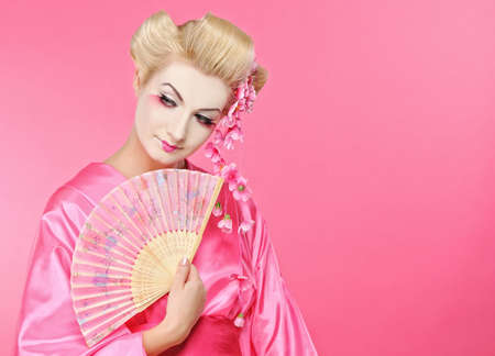 Beautiful geisha with a fanの写真素材