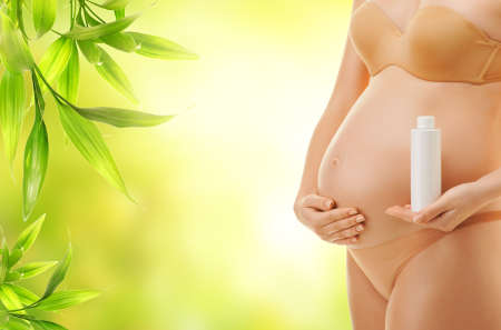  Pregnant woman with a bottle of oil 
の写真素材