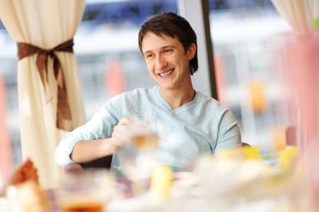 Happy man in a restaurantの写真素材