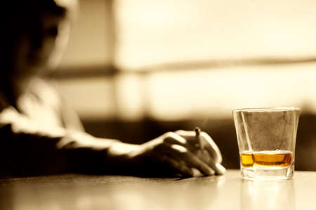 Smoking man with a glass of whisky and cigar の写真素材