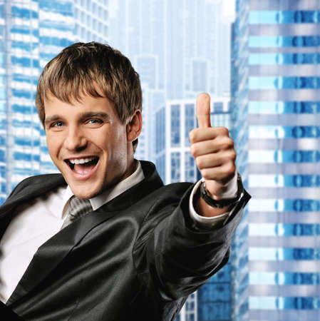 Happy businessman showing his thumb up with smile 
の写真素材