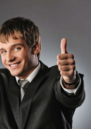 Happy businessman showing his thumb up with smile 
の写真素材