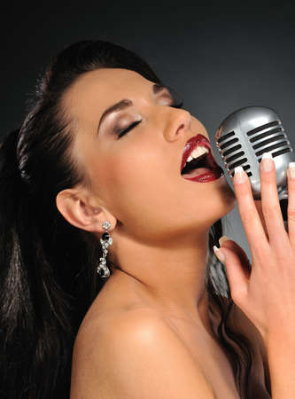 Beautiful brunette woman singingの写真素材