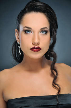 Attractive brunette woman isolated on grey backgroundの写真素材
